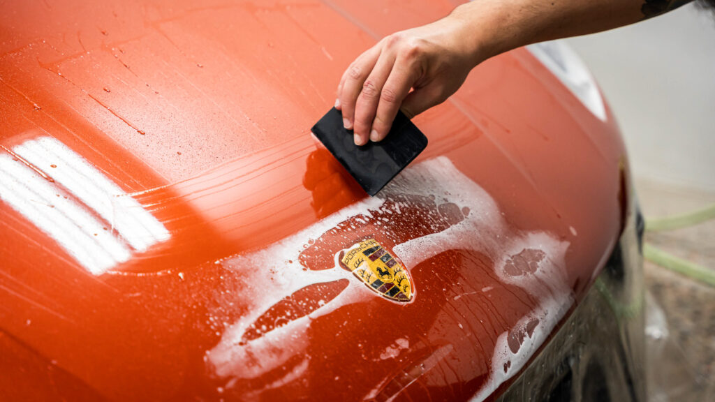 Removing slip solution during the paint protection film process