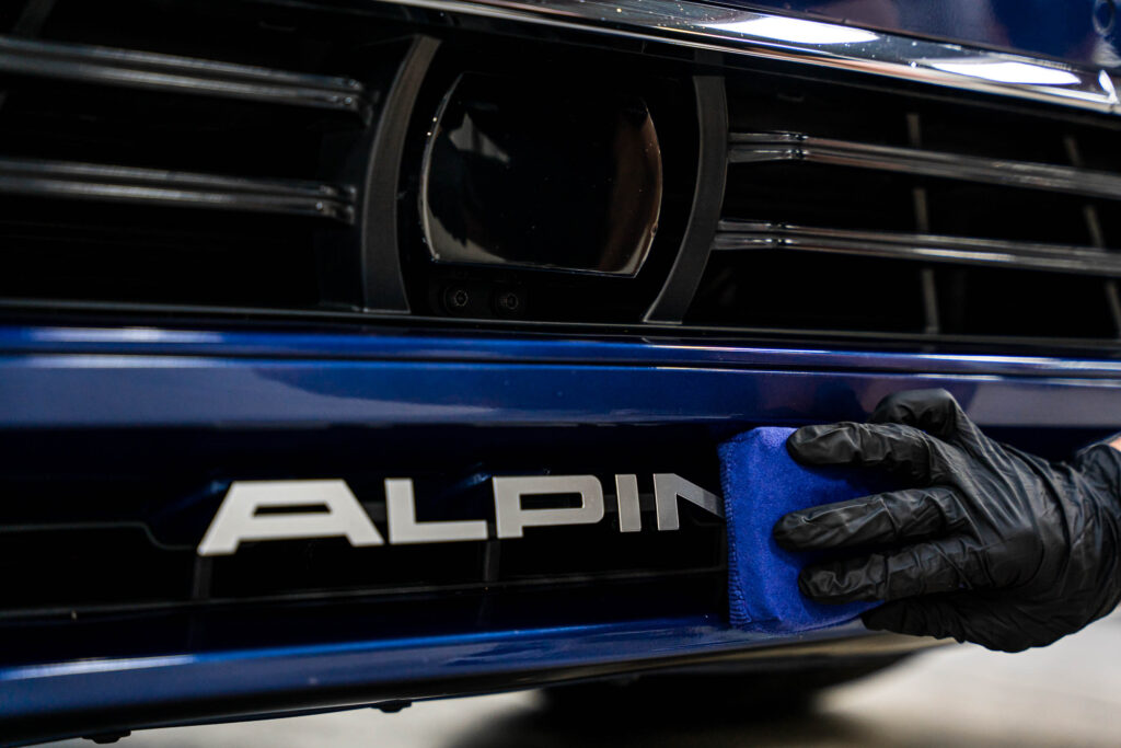 Ceramic coating being applied on Alpina badge
