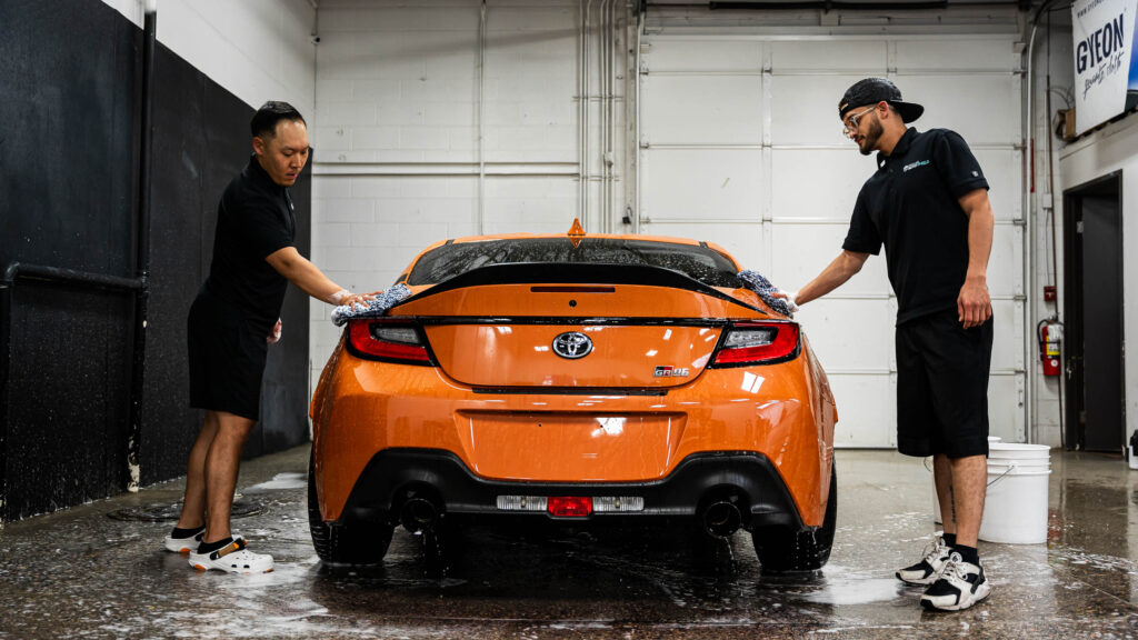 Detailers performing a contact wash