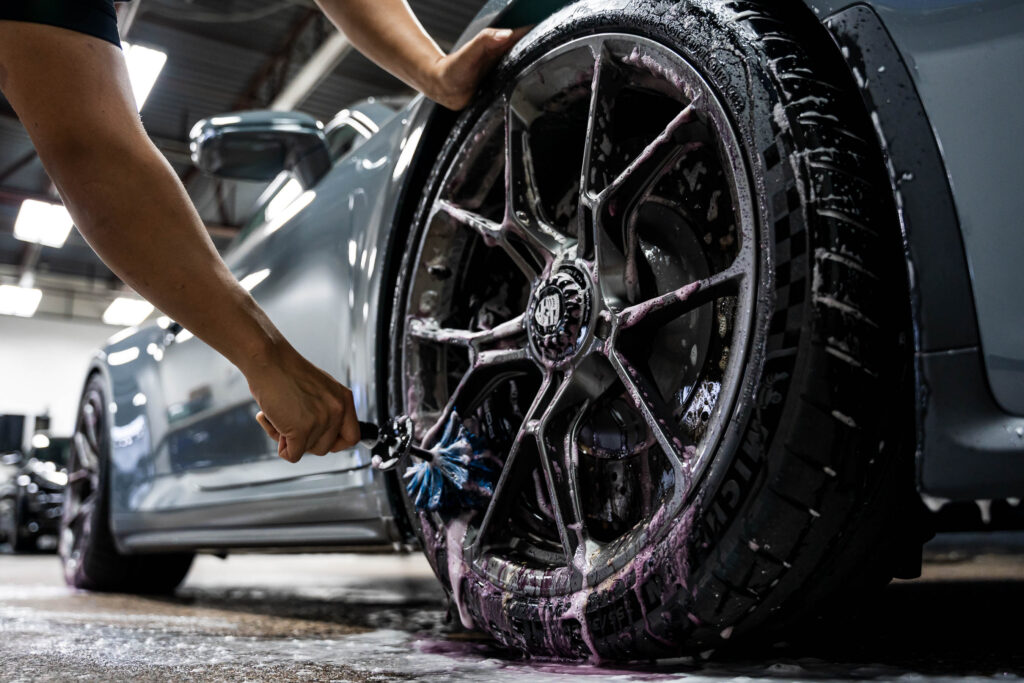 Cleaning wheels with a brush