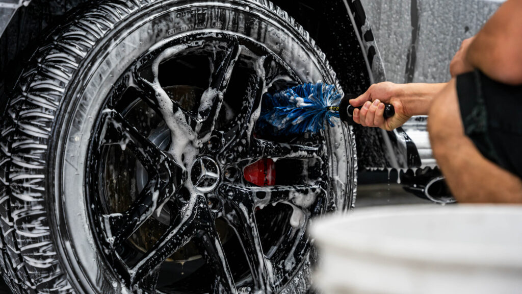 Using a brush to clean wheel