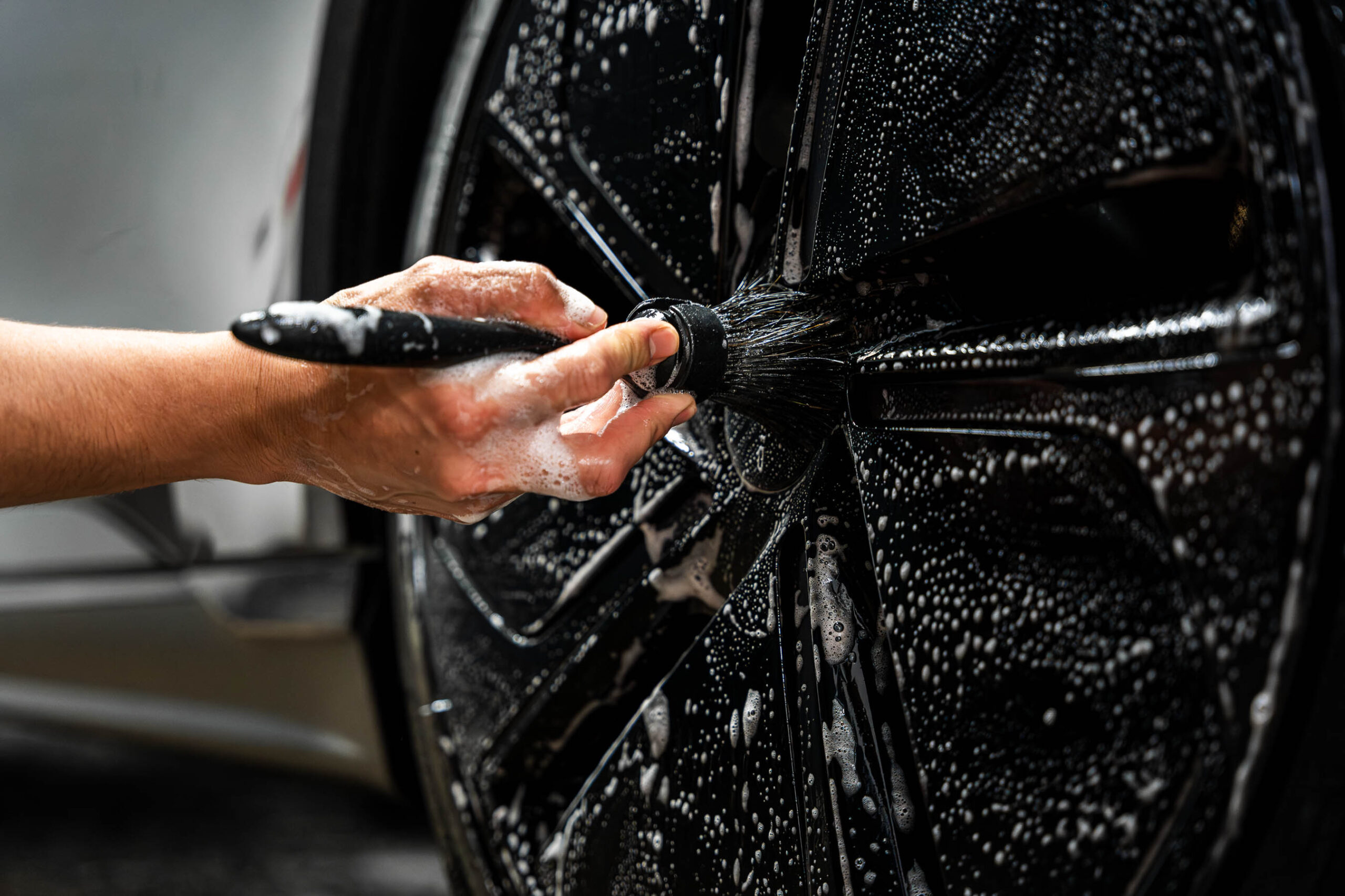 Using small brush to clean wheels