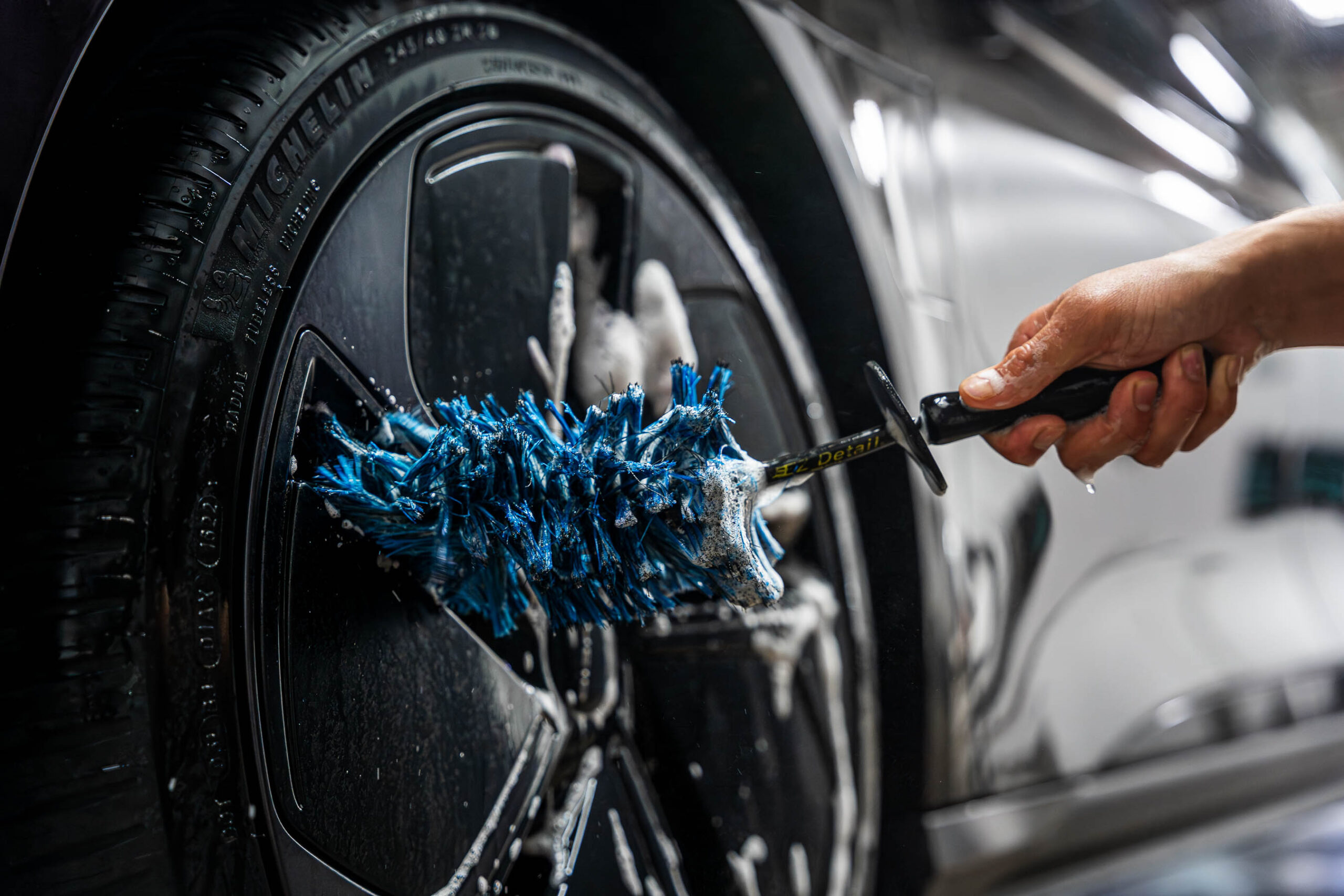 Using large brush to clean wheels