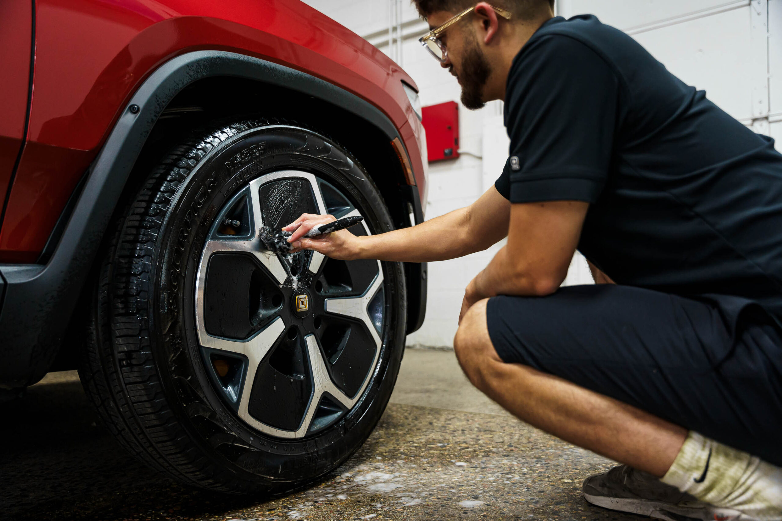 Using a detail brush to clean wheels