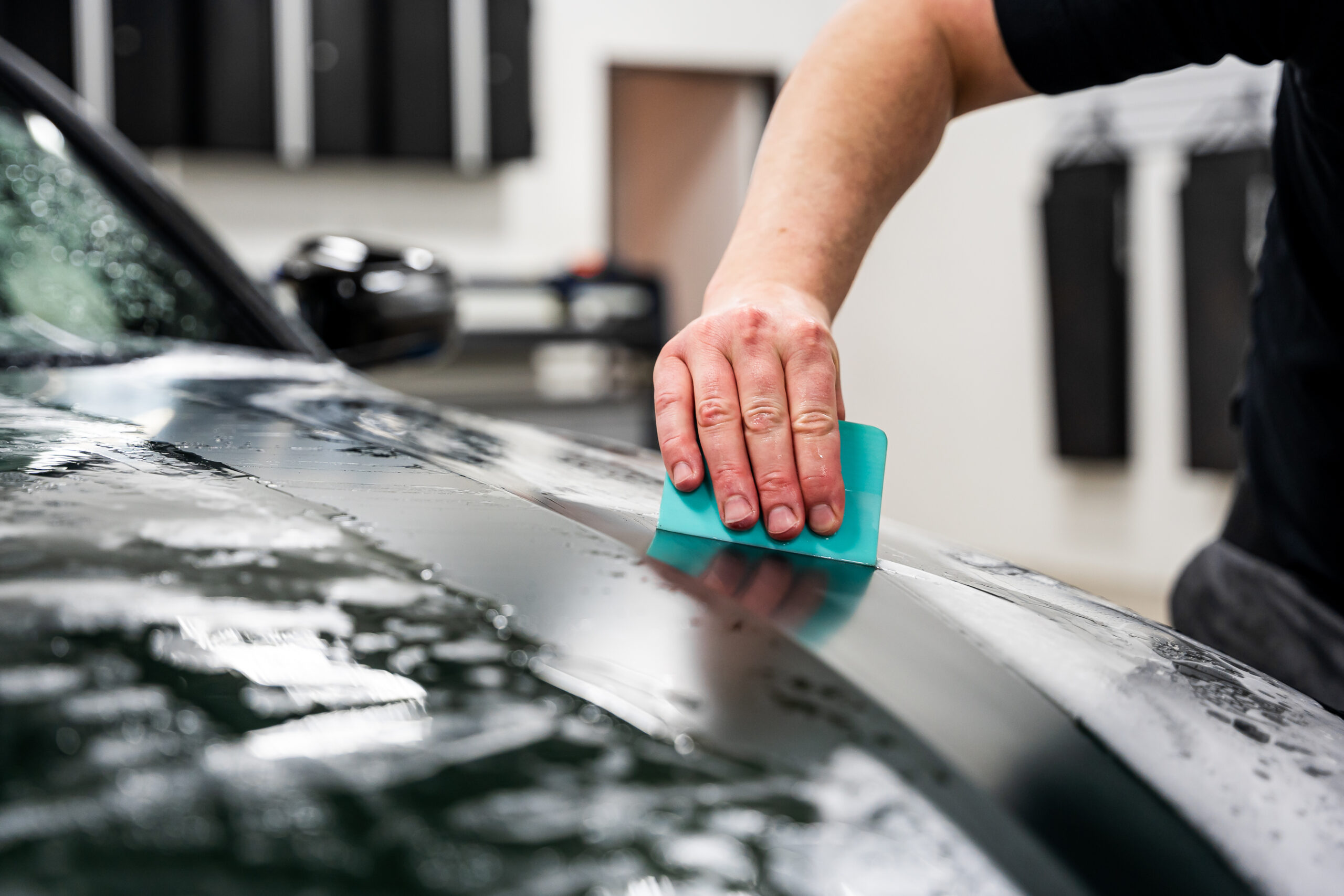 Using a squeegee to install PPF
